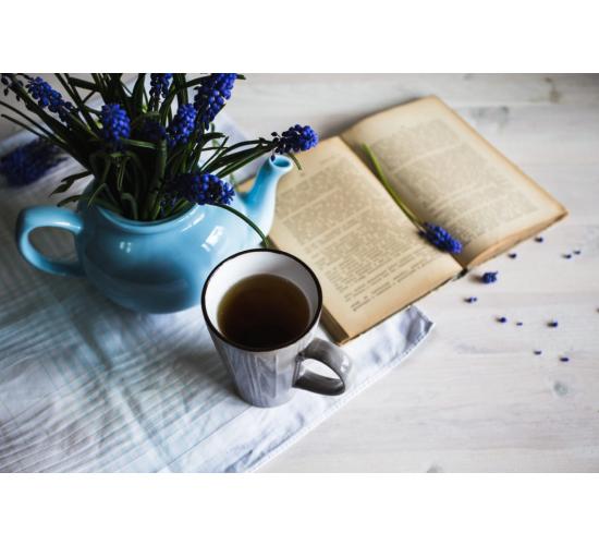cup of tea with blue flowers and a book on wooden PKJNRF7 1060x707